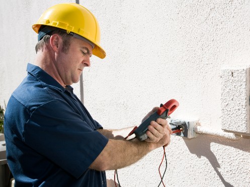 Electrician working a volt meter